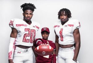 Senior Ismael Zamor (right), who will be playing football at Boston College, is shown here with his younger brothers Christian (left) and Jerol (middle).