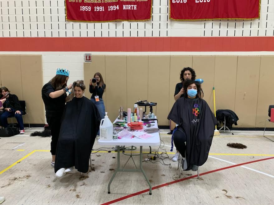 On the left, yearbook and digital art teacher Amanda Gil donates some of her locks while on the right, senior and event organizer Sarai Velez gets her hair straightened as a token of appreciation for her efforts in making it all happen.