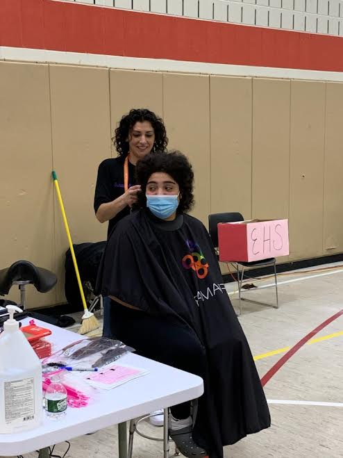 Sarai Velez, event organizer and leukemia survivor, gets her hair straightened as a thank-you for the effort she put into making this happen
