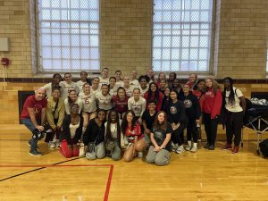 The EHS girls volleyball team, shown here alongside the Harvard Crimson volleyball team