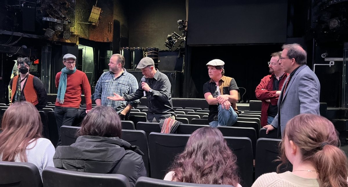 The cast and crew of Blue Man Group granting an informative and enlightening interview before the performance. From left to right: carpentry and automation supervisor John Parker, 
wardrobe and makeup supervisor Eliot Mohrmann, Blue Man captain Jason McLin, resident music director/ drummer Randy Wooten, Blue Man Adam Erdossy, string player Darren Ray, 
electric supervisor Paul Marr