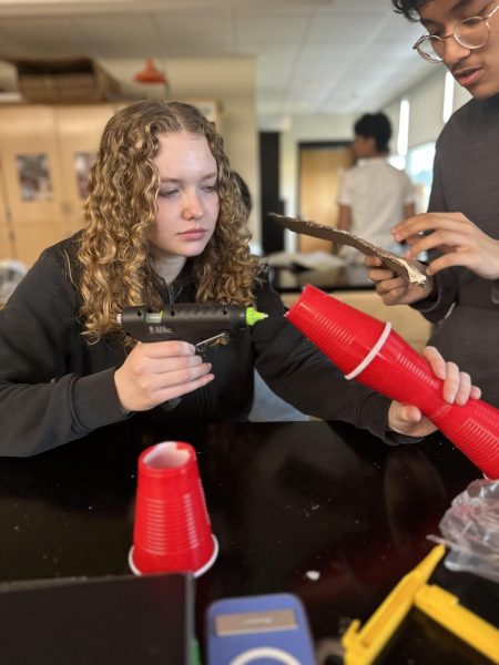 Sophomore Abigail Falkowski and Krivi Maharjan build the fastener.