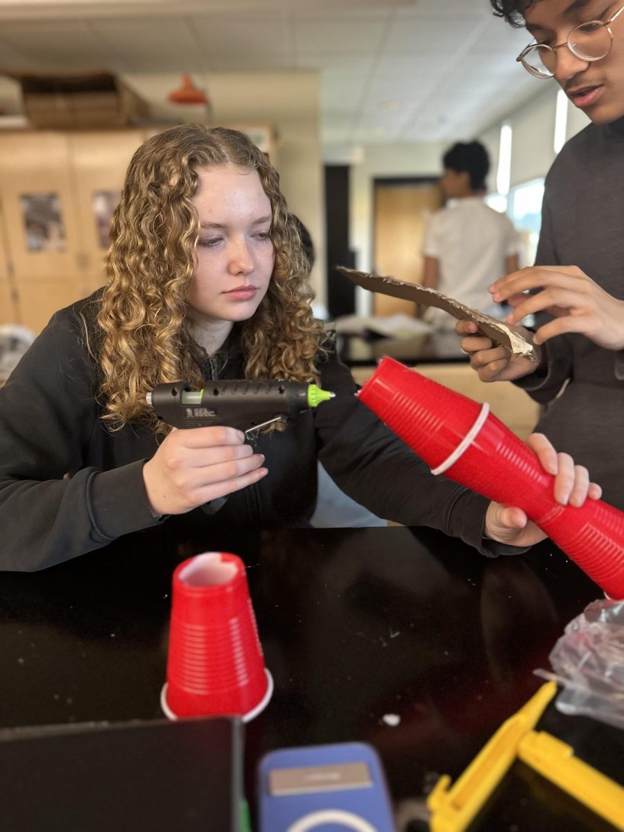 Sophomore Abigail Falkowski and Krivi Maharjan build the fastener.