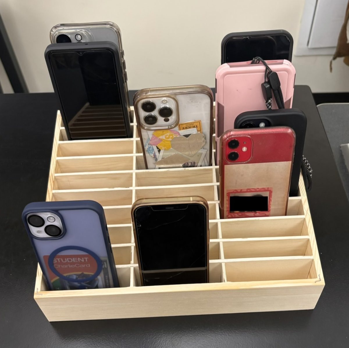 Phones sit in a caddy in chemistry class last week while students engage more presently in the lesson.
