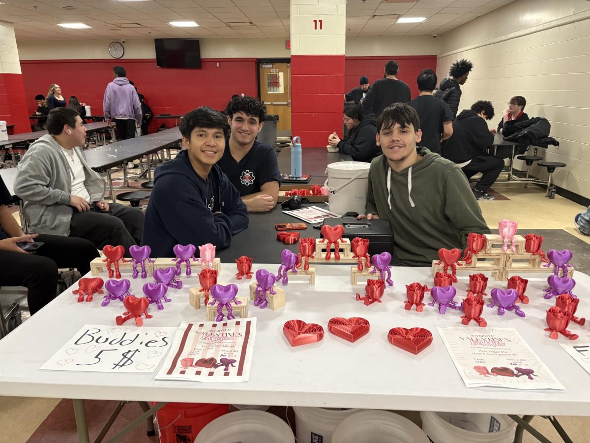 Advanced Manufacturing students selling Valentines Day themed items in the cafeteria