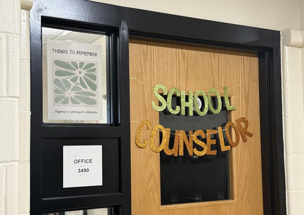 Room 3490 ,Counselor room door decorated with green letters and plant outlines.