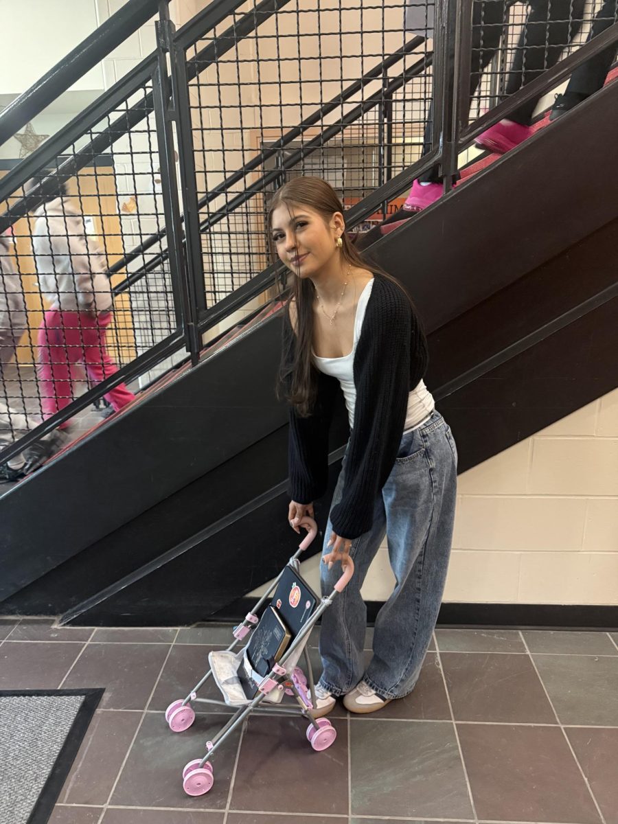 Senior Ashley Diaz pushing around a baby doll stroller for anything but a backpack day.